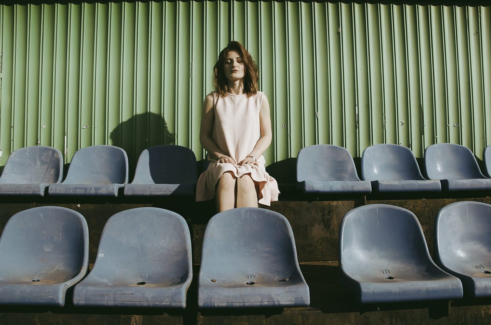 Woman sitting in stadium seats